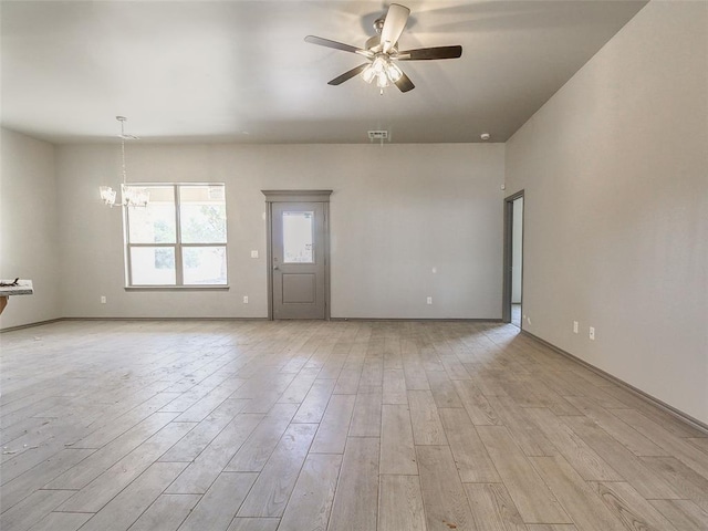 343787 E 870th Rd, Chandler, OK 74834 - spare room featuring visible vents, light wood-style flooring, ceiling fan with notable chandelier, and baseboards