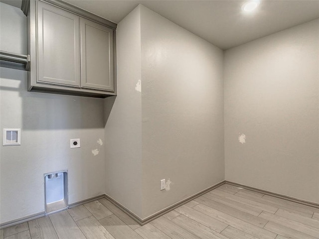 343787 E 870th Rd, Chandler, OK 74834 - laundry area with electric dryer hookup, light wood finished floors, cabinet space, and baseboards