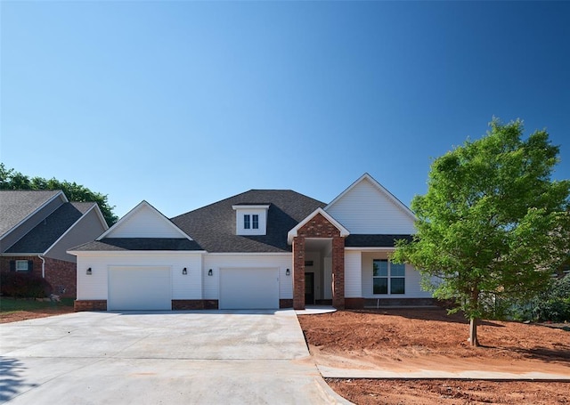 408 Nantucket Blvd, Norman, OK 73071 - view of front of house featuring a garage, driveway, brick siding, and a shingled roof