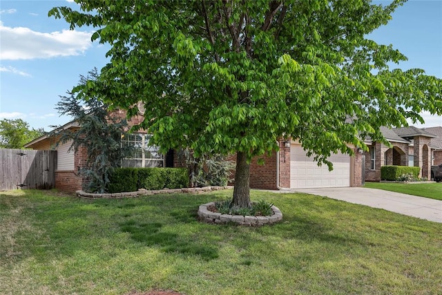 view of property hidden behind natural elements featuring brick siding, an attached garage, fence, and concrete driveway