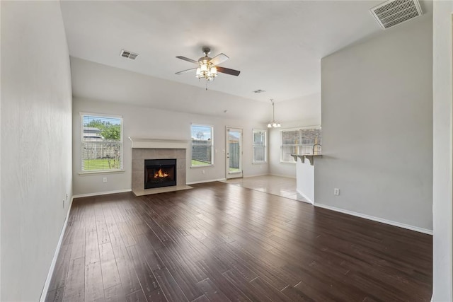unfurnished living room featuring a ceiling fan, baseboards, visible vents, and hardwood / wood-style floors