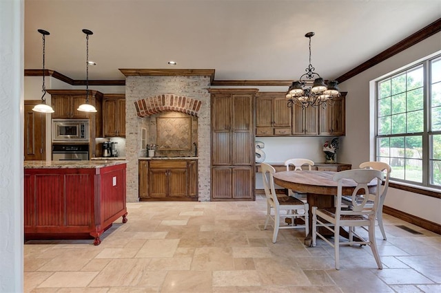 kitchen with visible vents, ornamental molding, baseboards, stone finish flooring, and appliances with stainless steel finishes