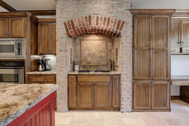 kitchen featuring light stone counters and stainless steel appliances