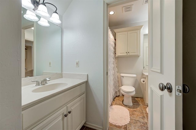 full bath featuring vanity, toilet, and visible vents
