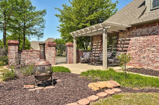 view of yard with fence, a pergola, an outdoor fire pit, a gate, and a patio