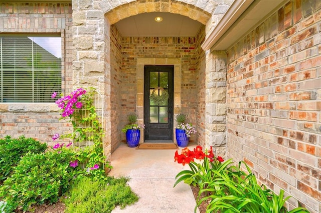 entrance to property with brick siding and stone siding