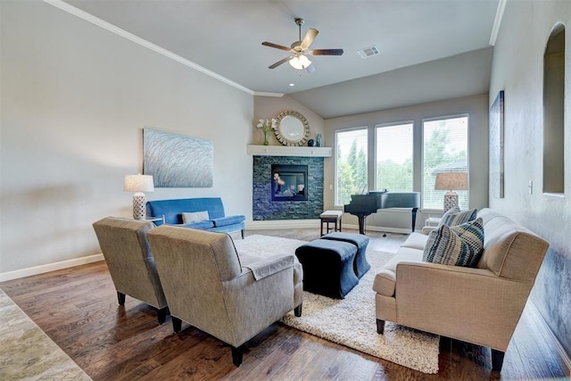 living room with ceiling fan, visible vents, a fireplace, wood finished floors, and baseboards