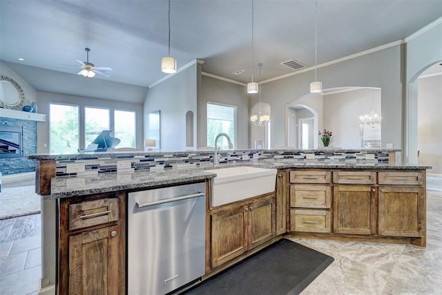 kitchen with visible vents, arched walkways, dishwasher, a sink, and ceiling fan with notable chandelier