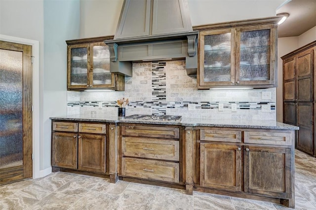 bar featuring decorative backsplash and stainless steel gas stovetop