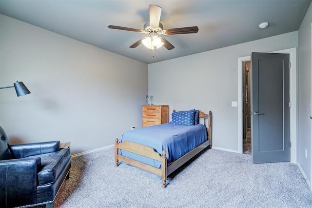 carpeted bedroom featuring baseboards and ceiling fan