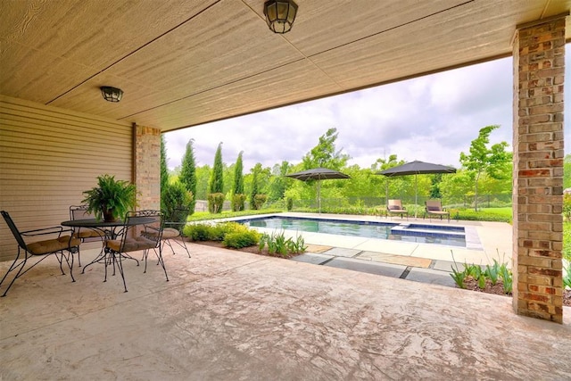 view of patio / terrace featuring a pool with connected hot tub