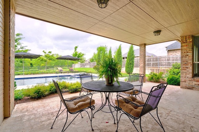 view of patio featuring a fenced in pool, a fenced backyard, and outdoor dining area