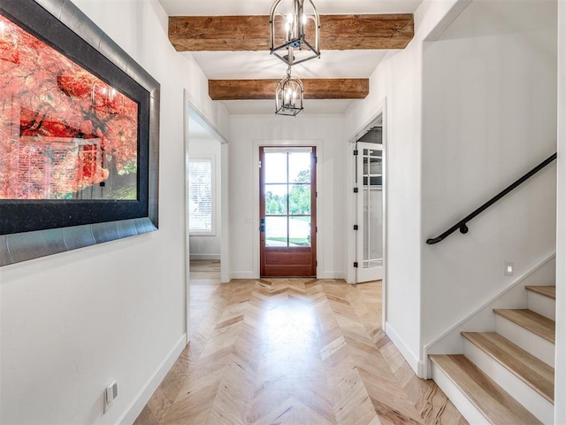 entrance foyer featuring stairway, baseboards, beamed ceiling, and a chandelier