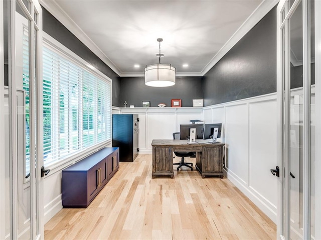home office with crown molding, light wood-style floors, a wainscoted wall, and a decorative wall