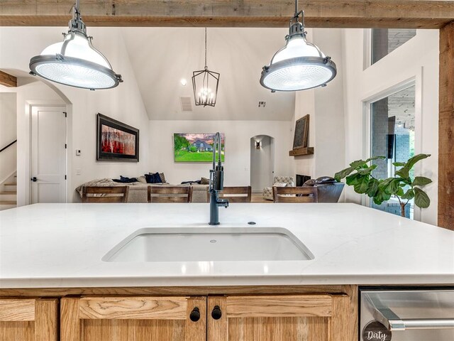 kitchen featuring a sink, light countertops, visible vents, and open floor plan