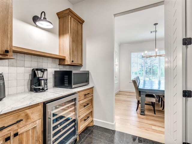 kitchen with visible vents, decorative backsplash, an inviting chandelier, beverage cooler, and stainless steel microwave