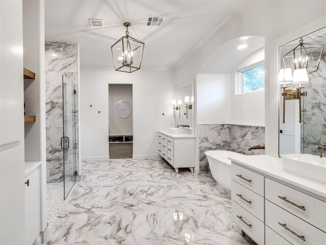 bathroom with an inviting chandelier, a sink, a marble finish shower, two vanities, and visible vents