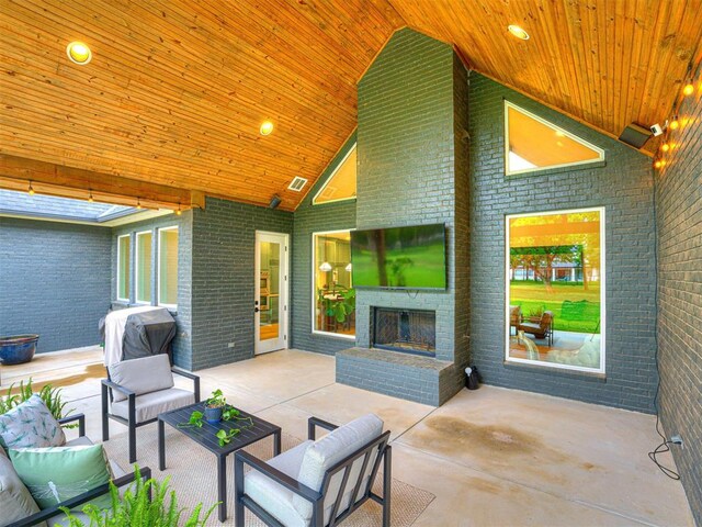 view of patio featuring visible vents and an outdoor living space with a fireplace