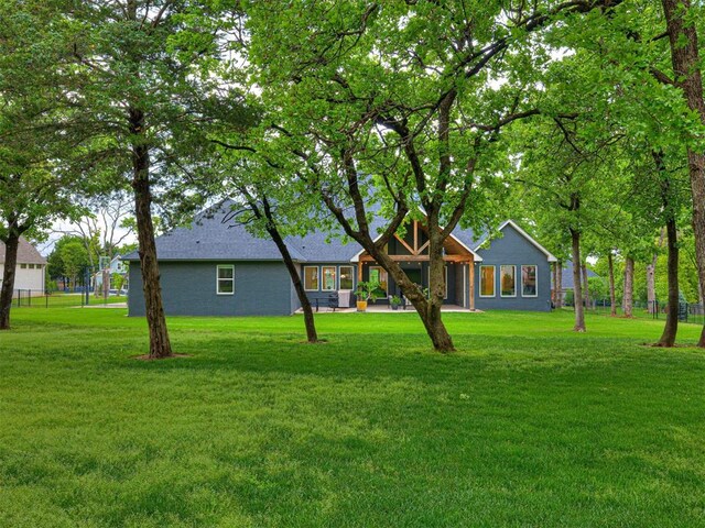 rear view of property with a yard