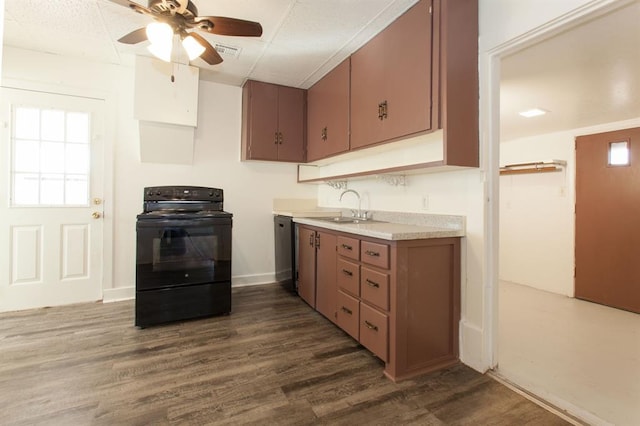 kitchen featuring black range with electric cooktop, ceiling fan, dark wood-type flooring, light countertops, and a sink