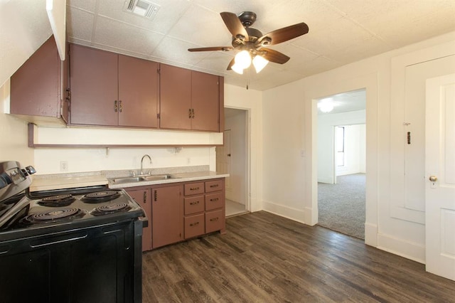 kitchen featuring visible vents, a ceiling fan, light countertops, black electric range, and a sink