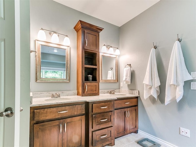 bathroom featuring double vanity, a sink, tile patterned flooring, and visible vents