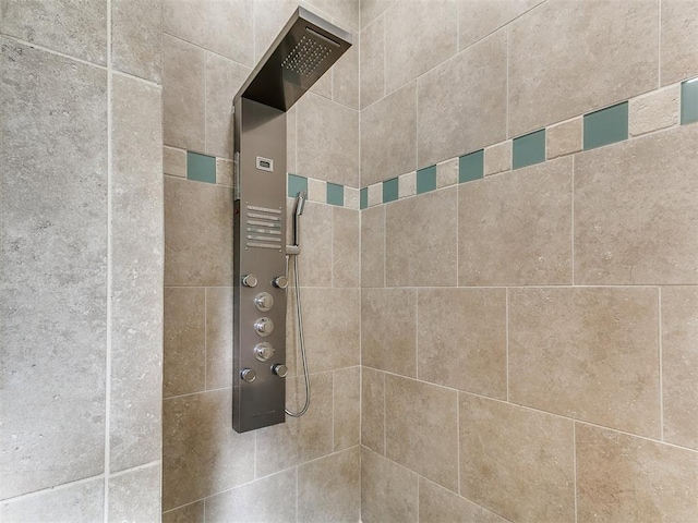 interior details featuring a tile shower