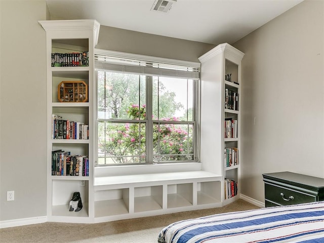 carpeted bedroom with visible vents, baseboards, and multiple windows