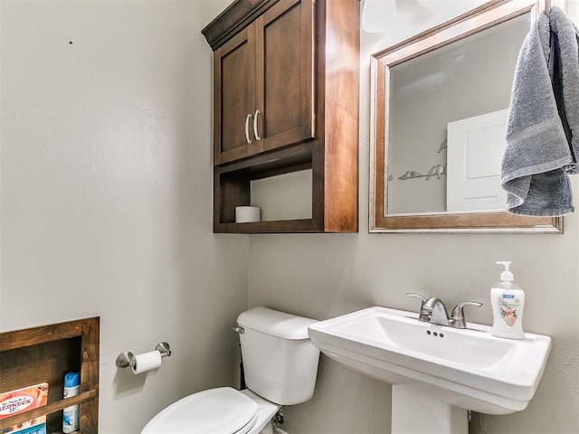 half bathroom with toilet and a sink