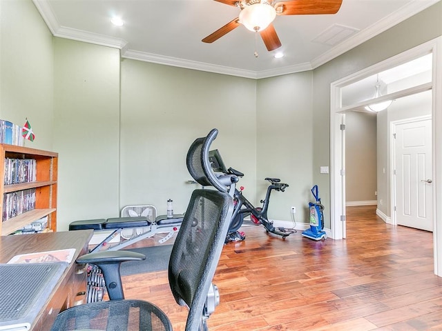 workout area featuring a ceiling fan, baseboards, ornamental molding, and wood finished floors
