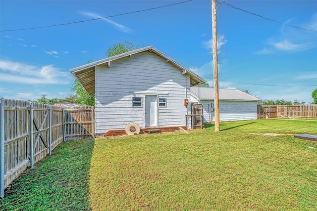 back of property featuring a lawn and a fenced backyard