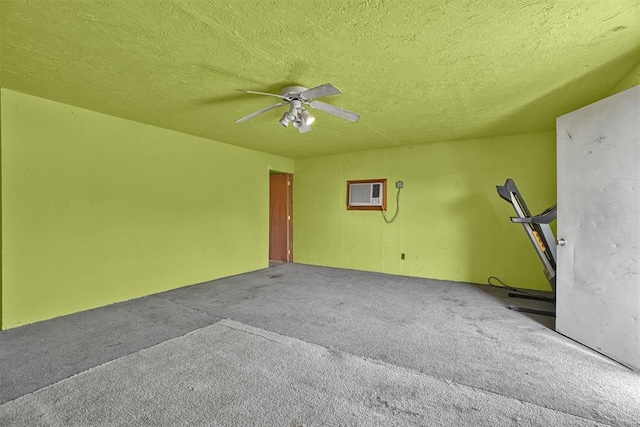 carpeted spare room with a textured ceiling and ceiling fan