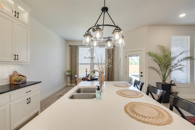 dining area with recessed lighting, baseboards, a notable chandelier, and wood finished floors