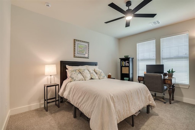bedroom featuring visible vents, a ceiling fan, baseboards, and light colored carpet