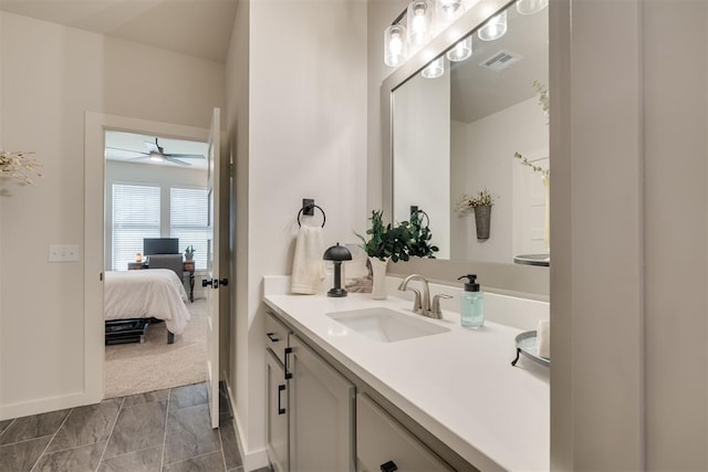 ensuite bathroom with vanity, a ceiling fan, baseboards, ensuite bathroom, and visible vents
