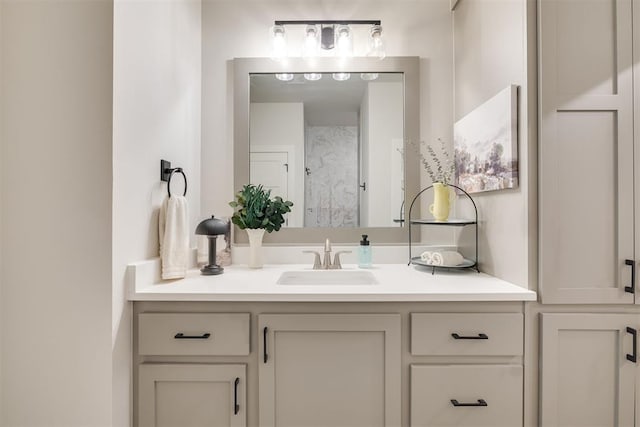 bathroom featuring walk in shower and vanity