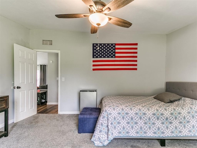 carpeted bedroom featuring baseboards, visible vents, and ceiling fan