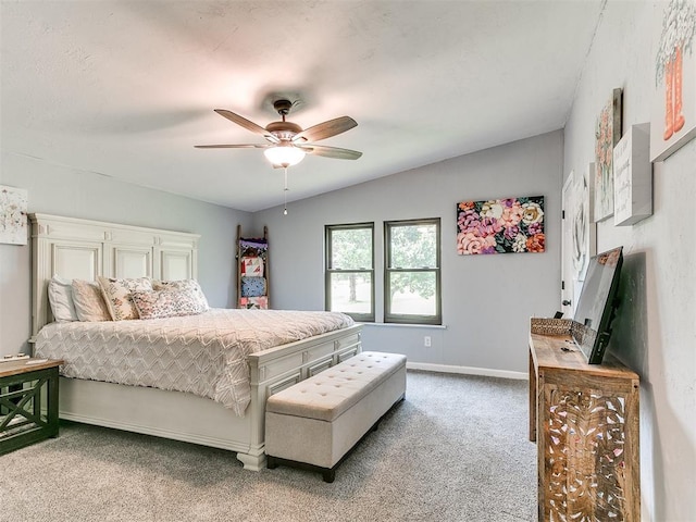 carpeted bedroom featuring baseboards, a ceiling fan, and lofted ceiling
