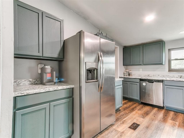 kitchen featuring light wood-type flooring, visible vents, and stainless steel appliances