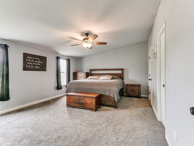 carpeted bedroom featuring baseboards and ceiling fan