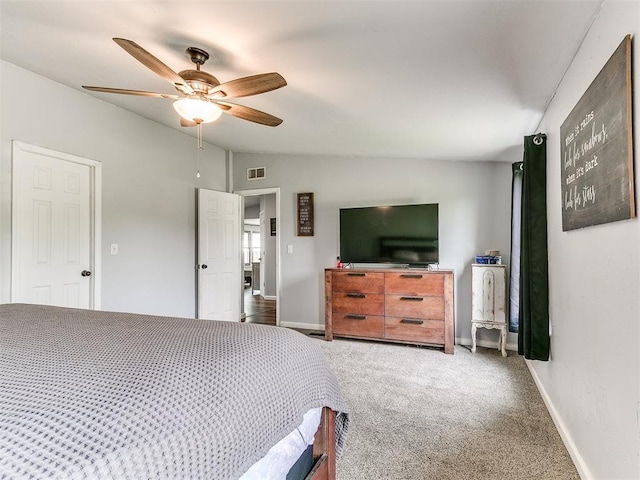 bedroom featuring visible vents, lofted ceiling, baseboards, ceiling fan, and carpet flooring