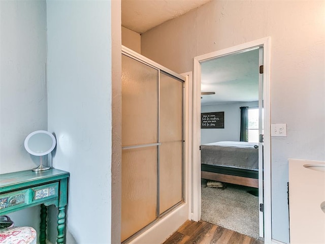 full bathroom featuring ensuite bathroom, wood finished floors, and a shower stall