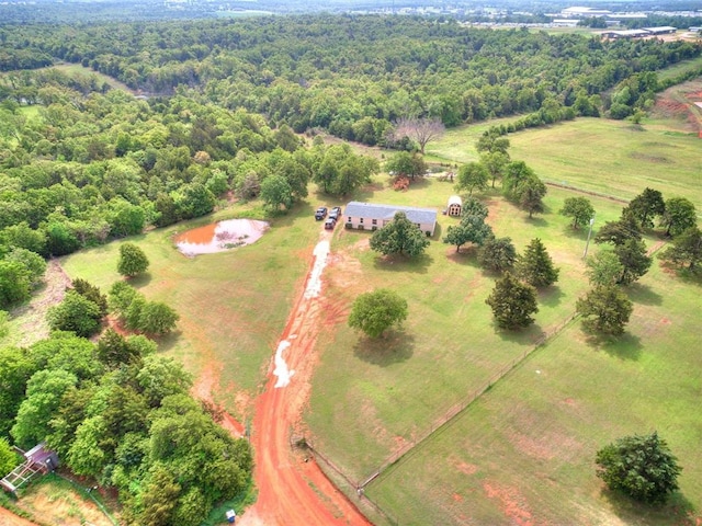 bird's eye view with a view of trees and a rural view