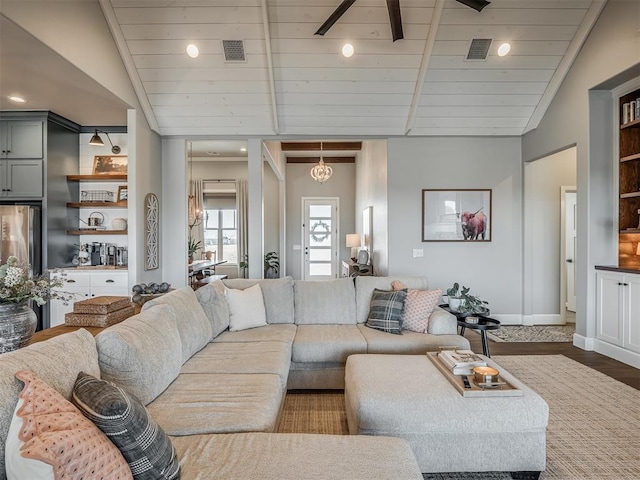 living room featuring baseboards, visible vents, wood finished floors, and lofted ceiling