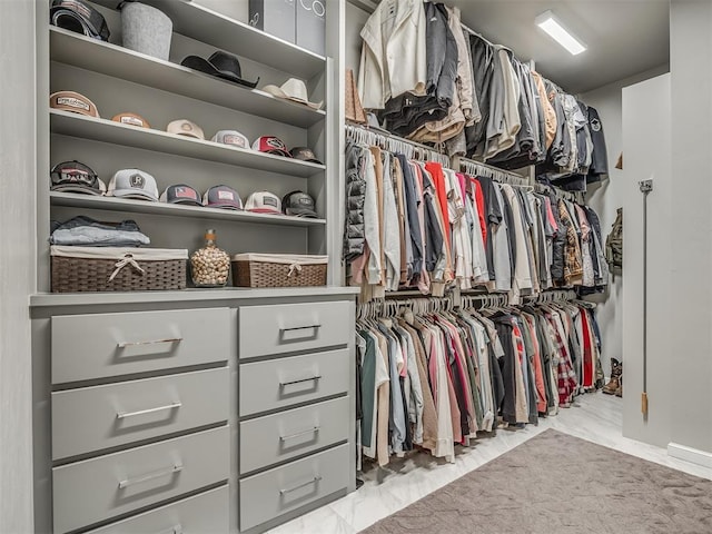 spacious closet featuring marble finish floor