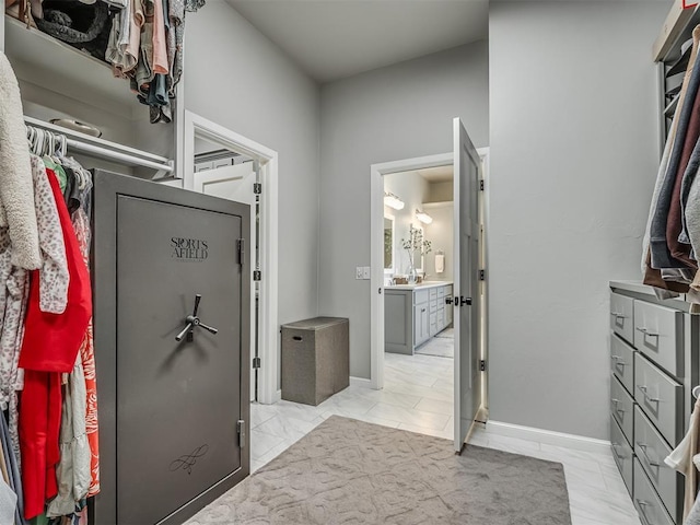 spacious closet with marble finish floor