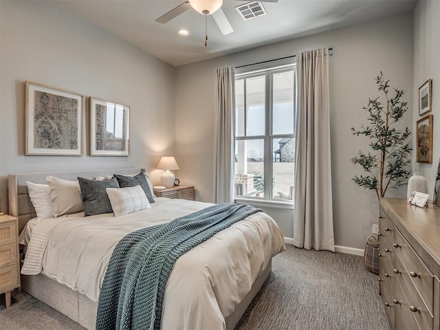 bedroom with carpet flooring, baseboards, visible vents, and multiple windows