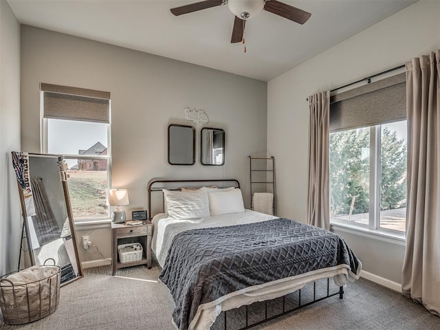 carpeted bedroom with baseboards and a ceiling fan