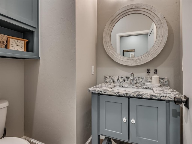 bathroom with toilet and vanity