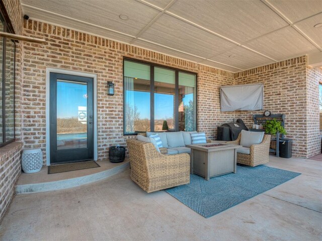 view of patio featuring an outdoor living space with a fire pit